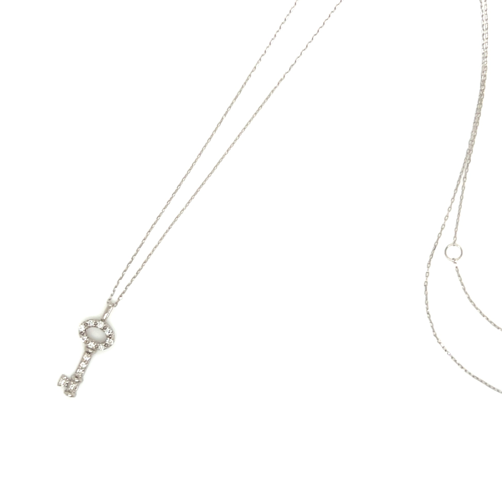 A silver key-shaped pendant necklace adorned with clear rhinestones, shown on a delicate chain against a plain white background.