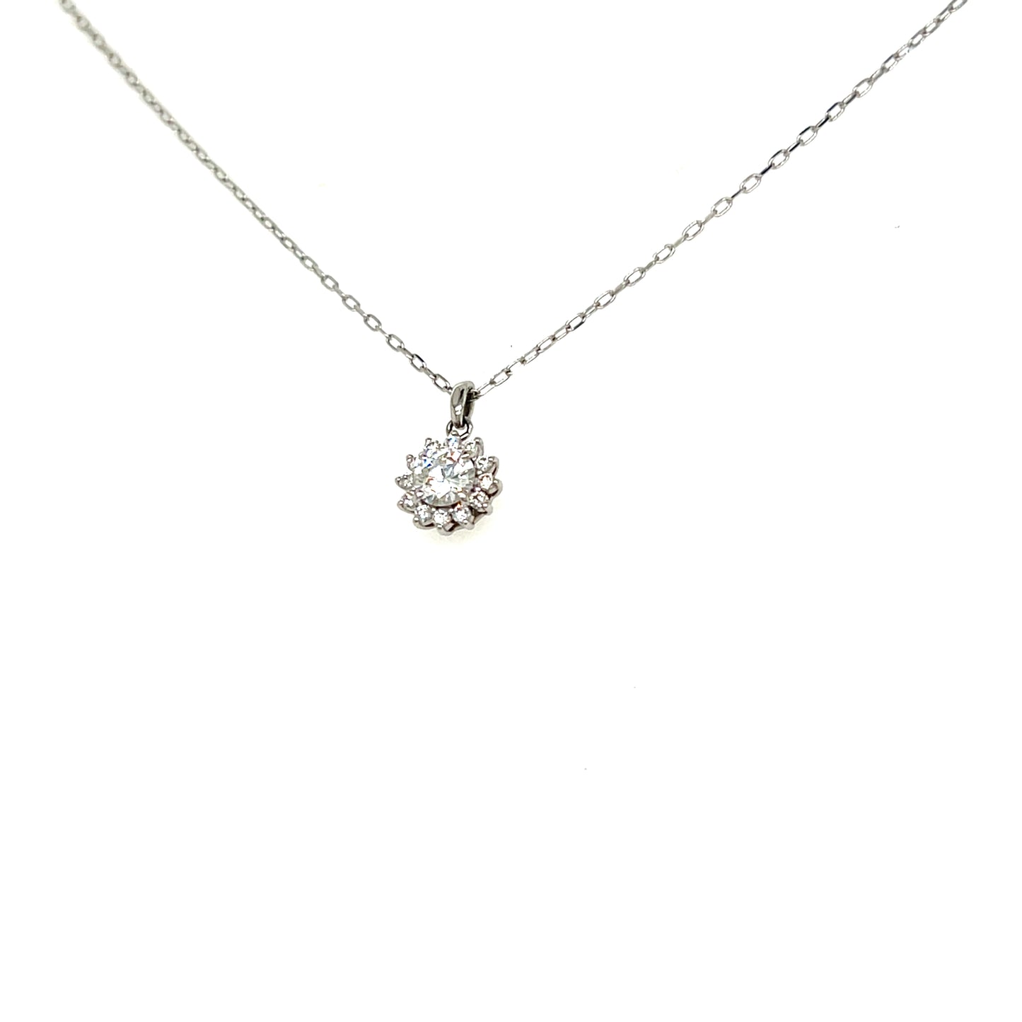 A delicate silver chain necklace with a small floral cluster pendant featuring a clear central gemstone, shown against a plain white background.