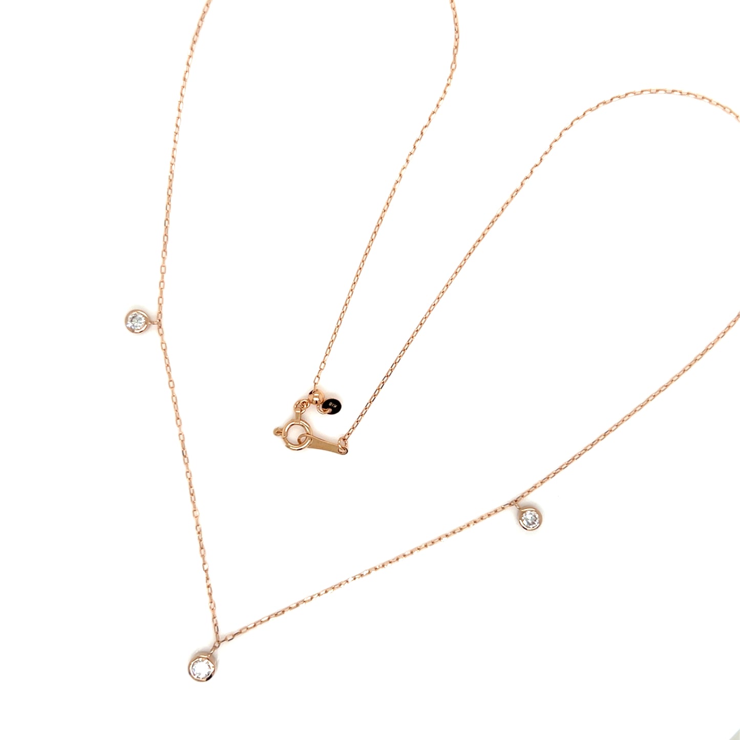 Rose gold necklace with heart pendant and small diamonds on a white background