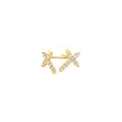 A yellow gold ring featuring a central emerald-cut clear gemstone surrounded by a halo, with a delicate pavé band on either side, shown against a light gray background.