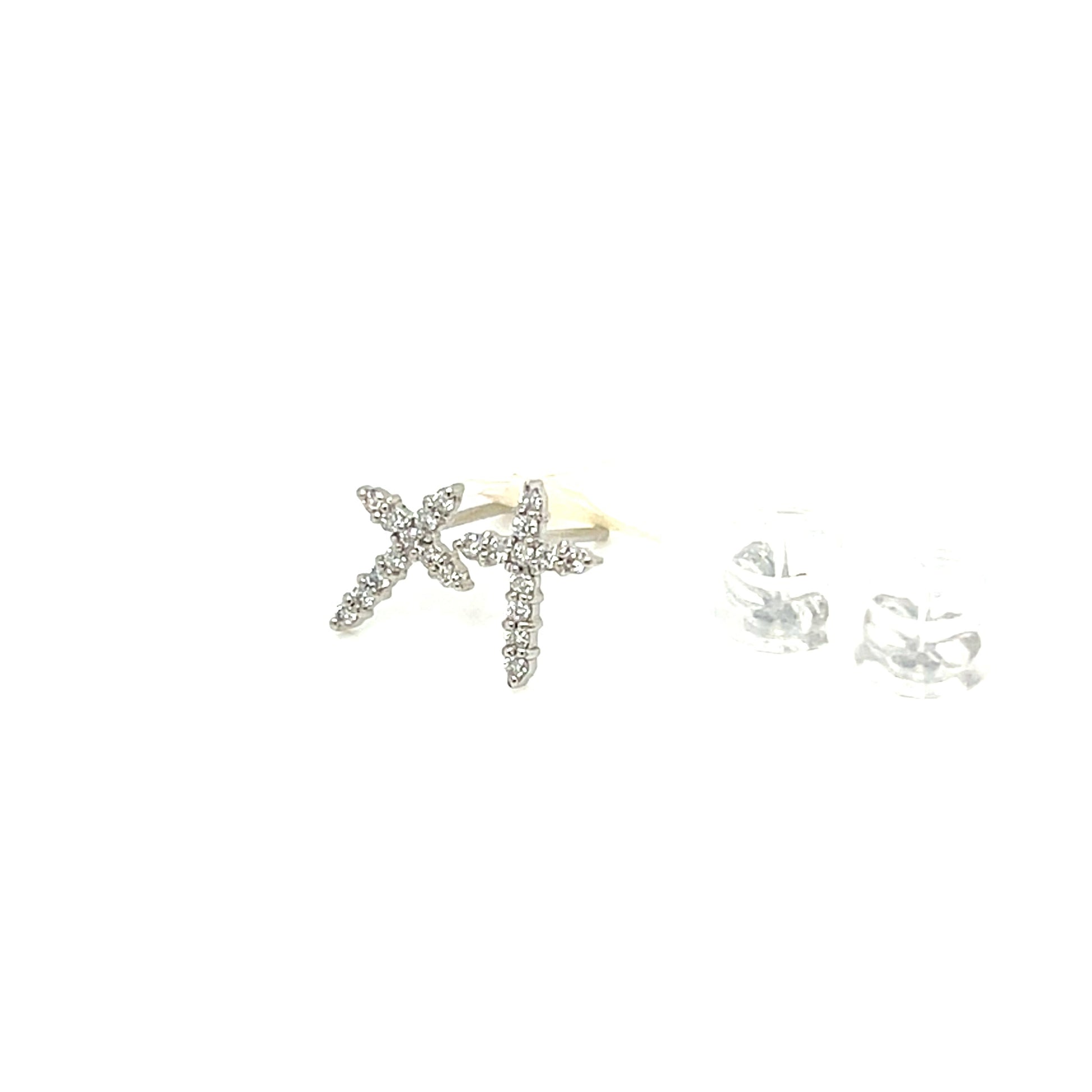 A pair of silver-toned starfish stud earrings embellished with clear rhinestones, shown next to a pair of matching clear crystal stud earrings on a solid white background.