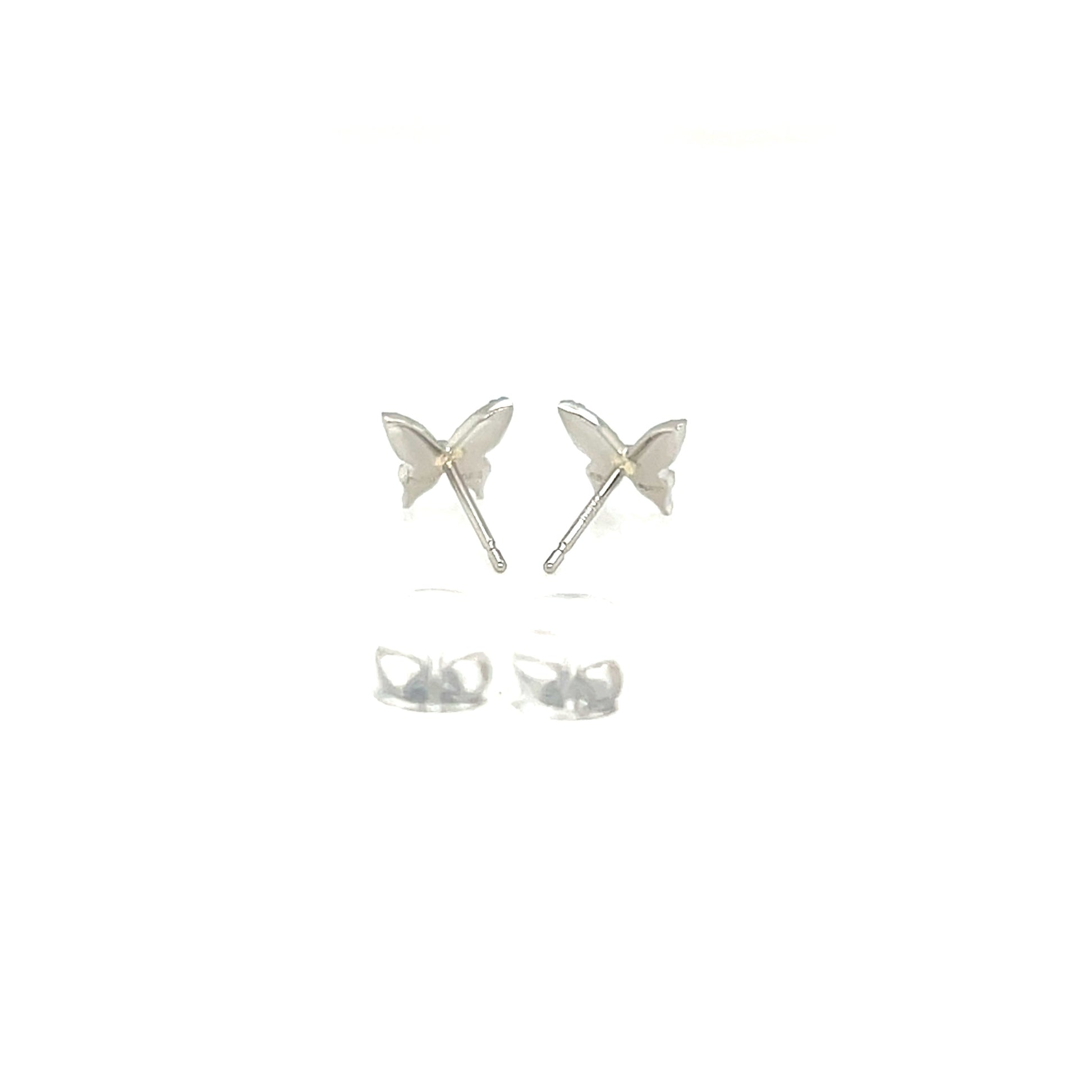 Butterfly-shaped silver earrings on a white background