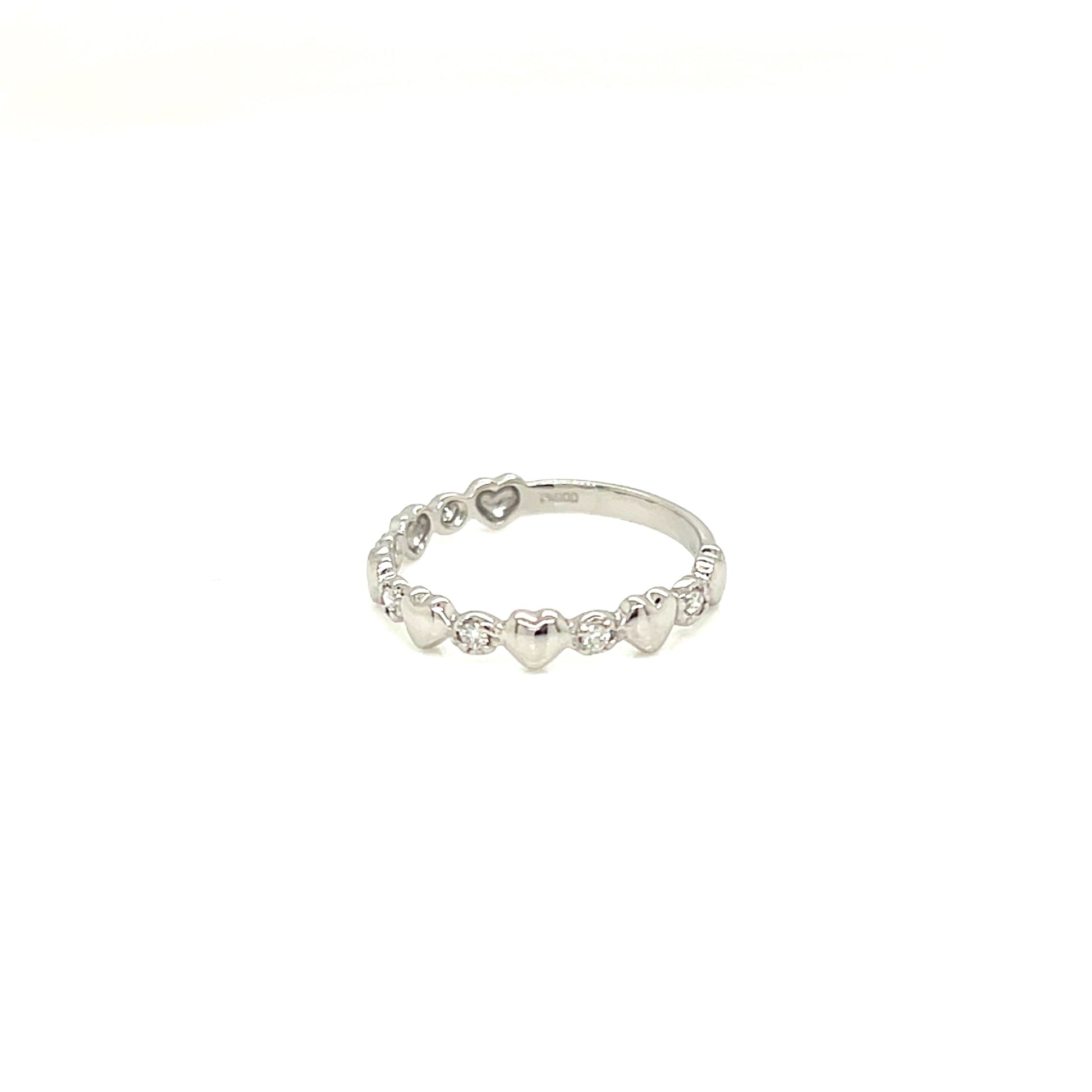 A delicate silver band ring featuring a row of small, evenly spaced heart charms, photographed against a solid white background.