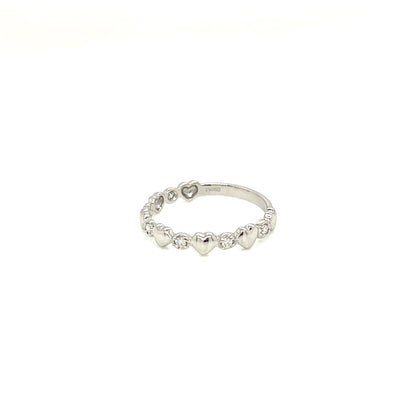 A delicate silver band ring featuring a row of small, evenly spaced heart charms, photographed against a solid white background.