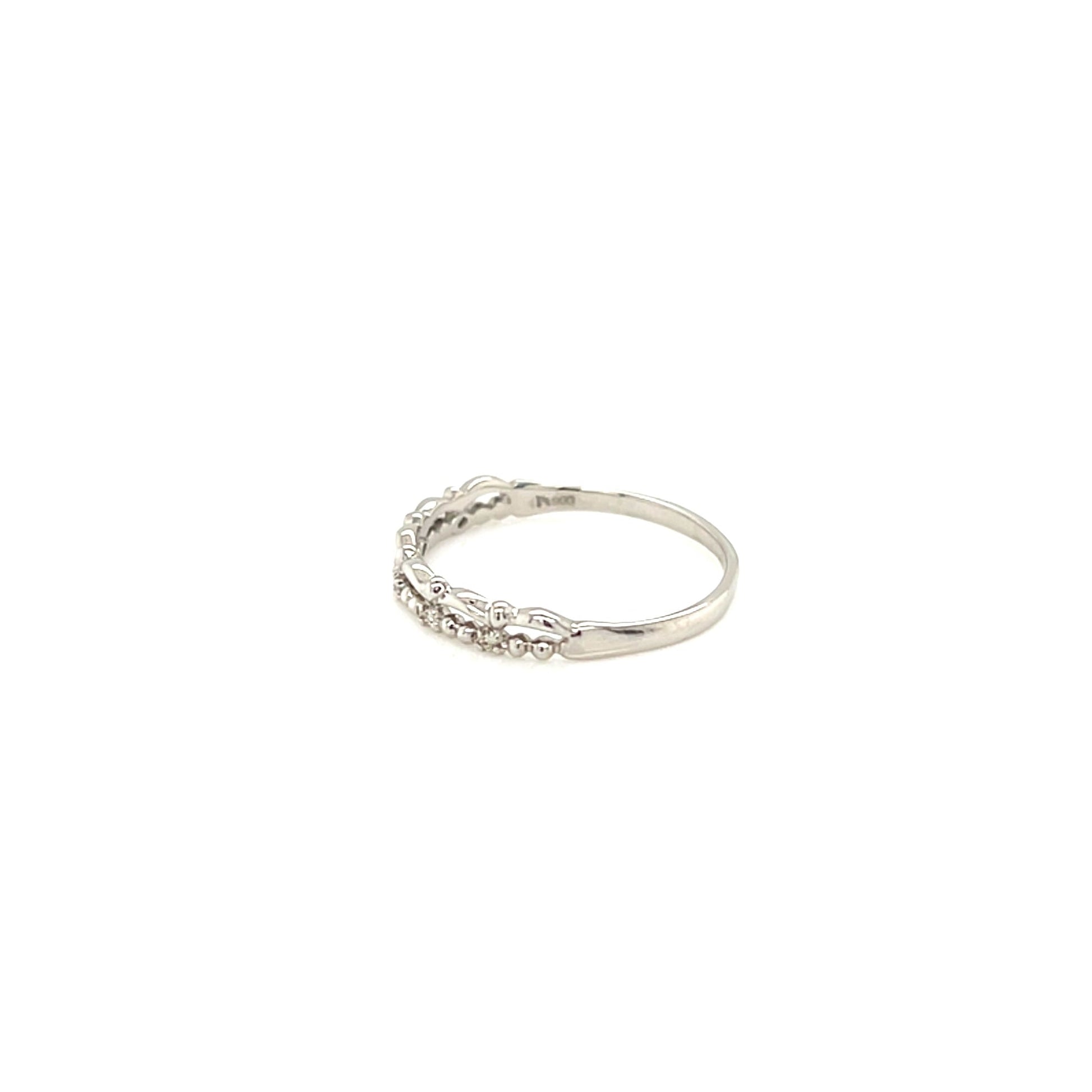 Silver ring with small stones on a white background