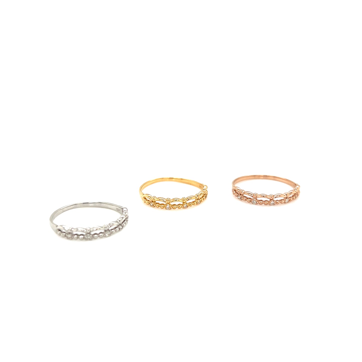 Three rings in silver, gold, and rose gold on a white background