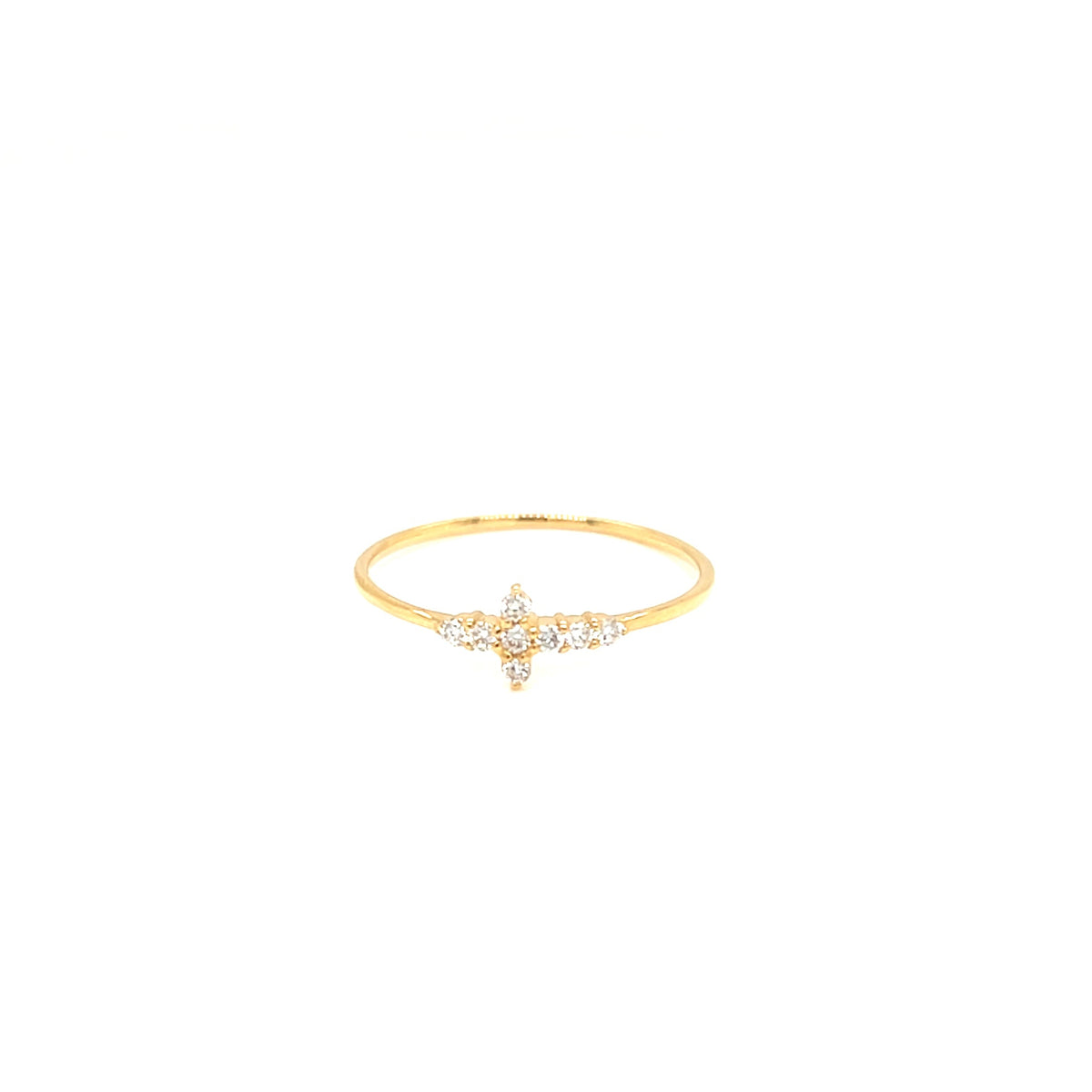A delicate gold ring featuring a small star-shaped cluster of clear gemstones at the center, set against a plain white background.