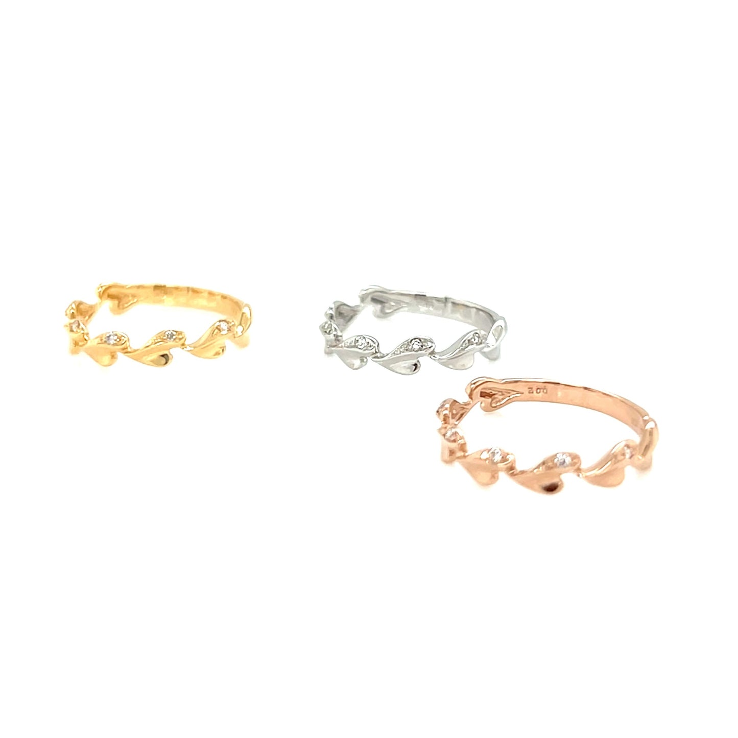 Three gold, silver, and rose gold rings on a white background