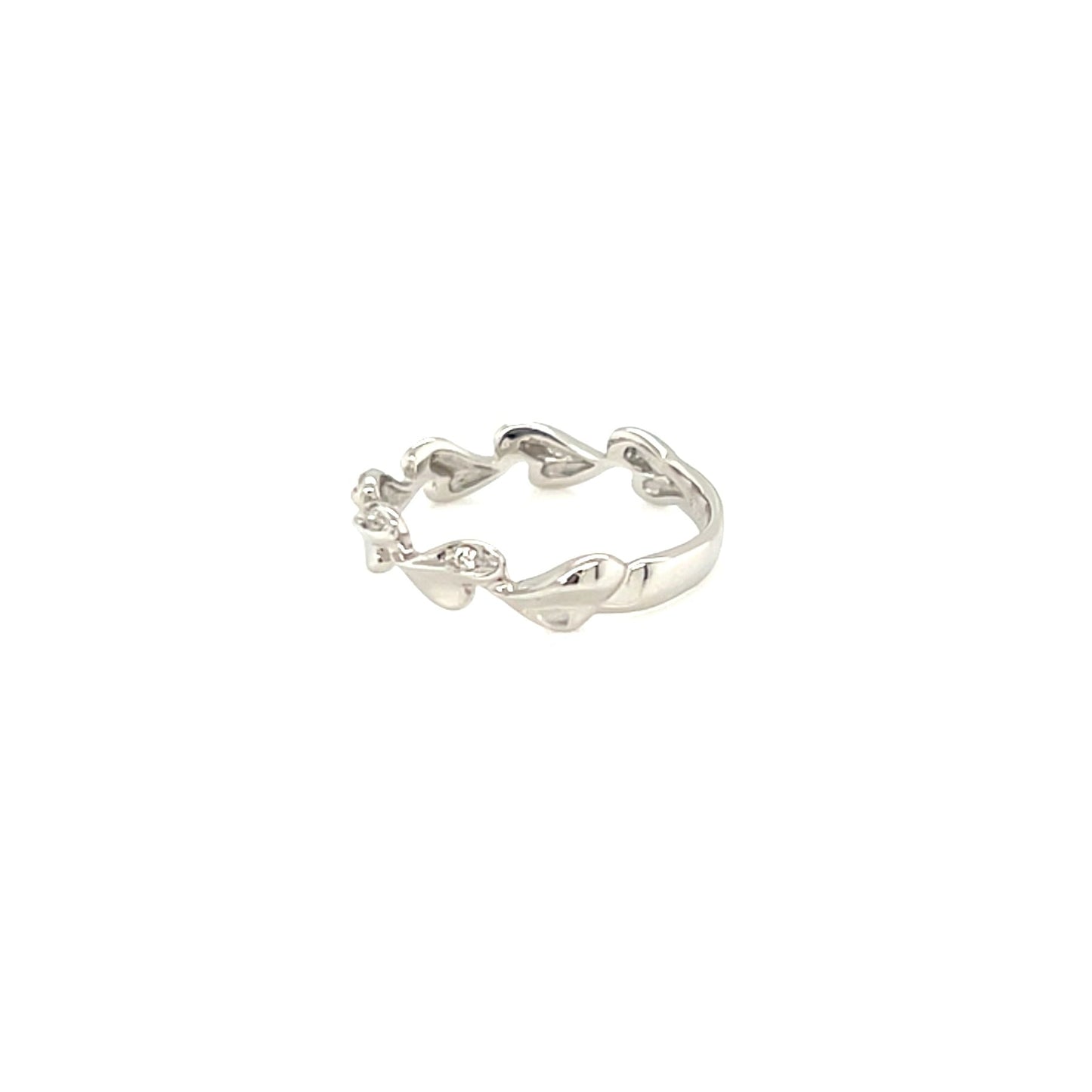 Silver ring with a heart design on a white background