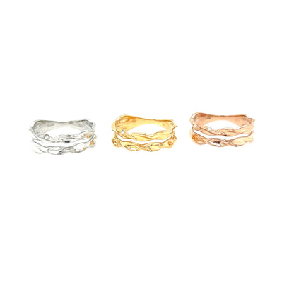 Three rings in silver, gold, and rose gold on a white background