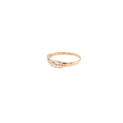 Rose gold ring with small diamonds on a white background