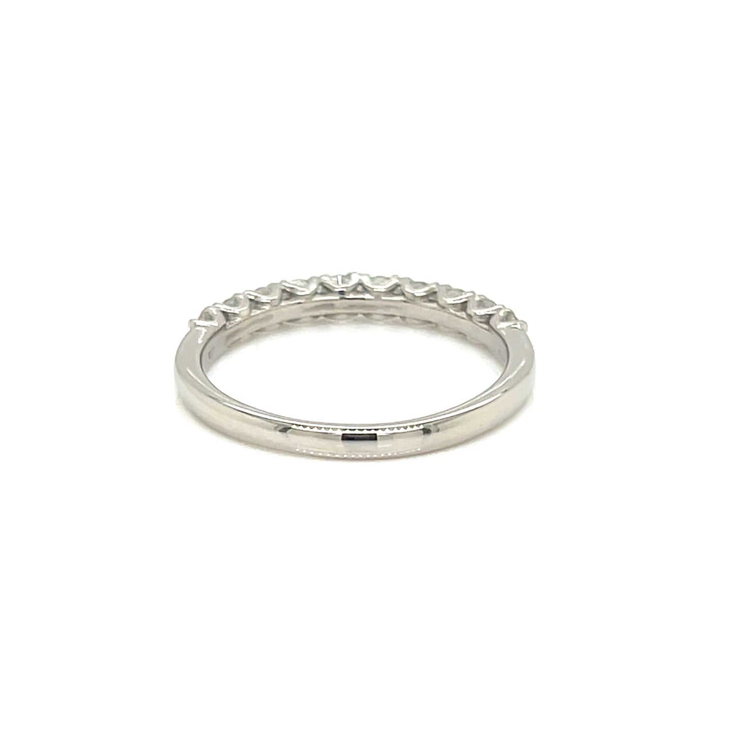 A silver eternity band ring with a row of small clear stones set around the outer edge, shown on a plain white background.