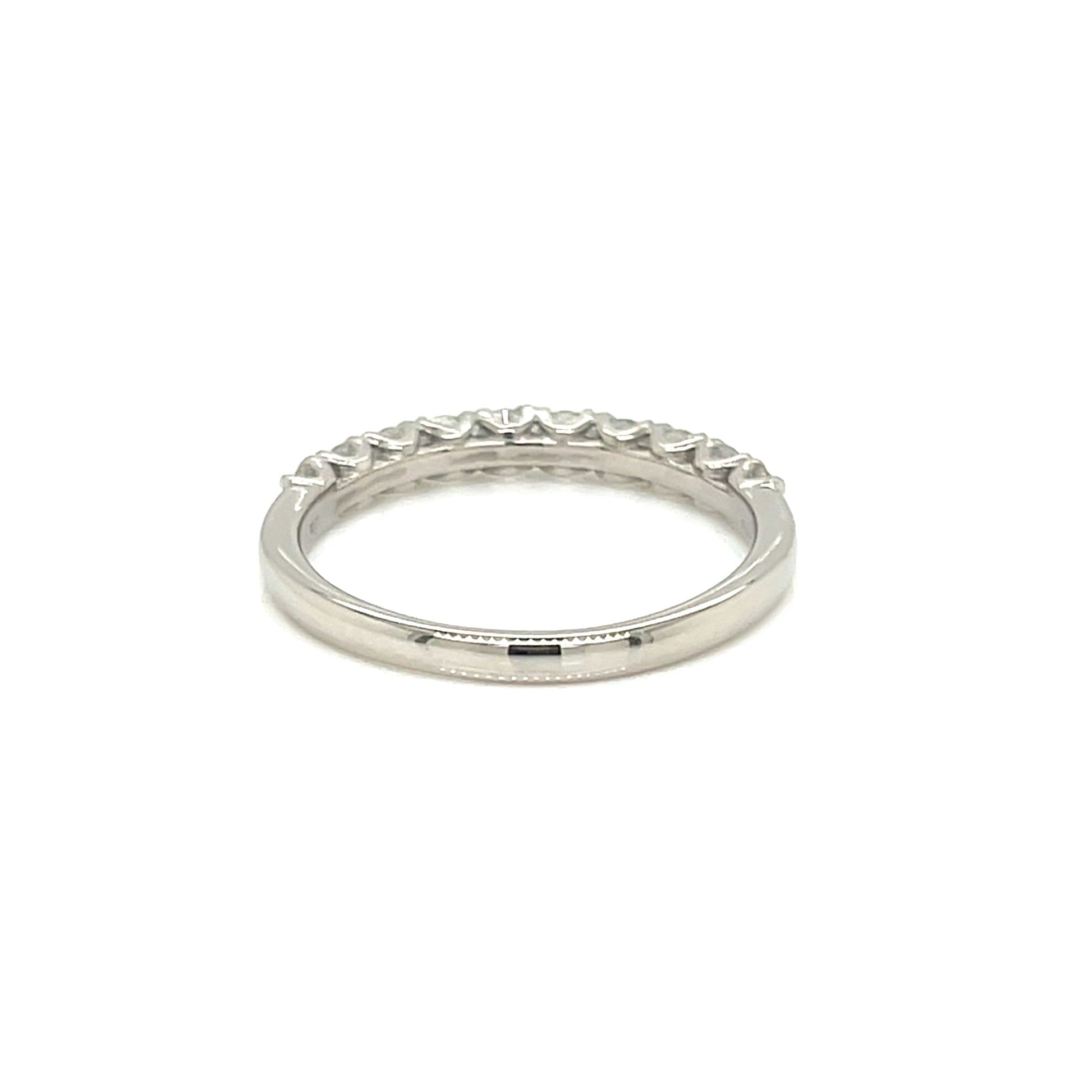A silver eternity band ring with a row of small clear stones set around the outer edge, shown on a plain white background.