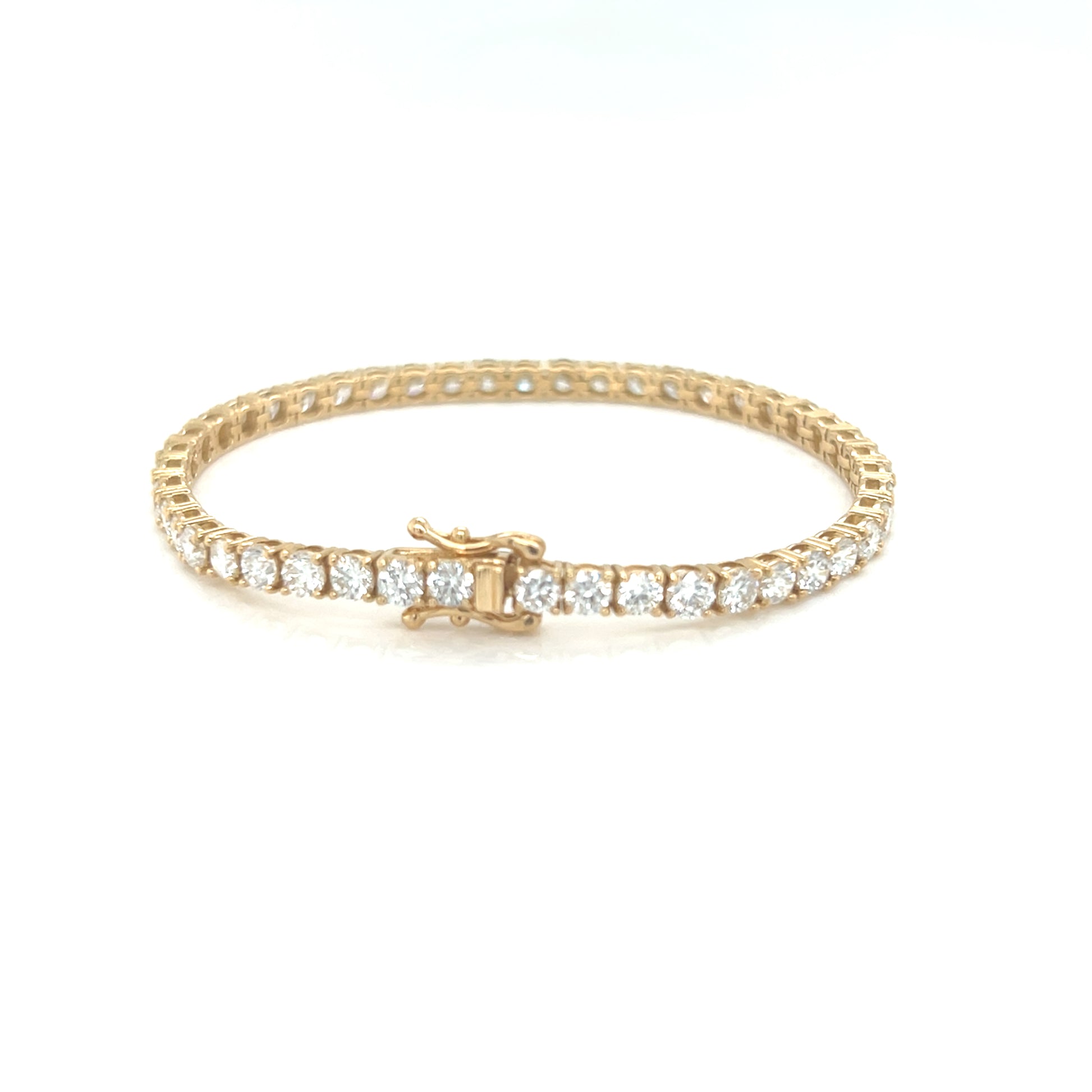 Gold bracelet with diamonds on a white background
