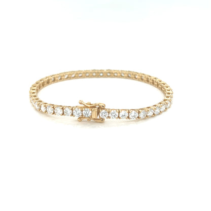 Gold bracelet with diamonds on a white background