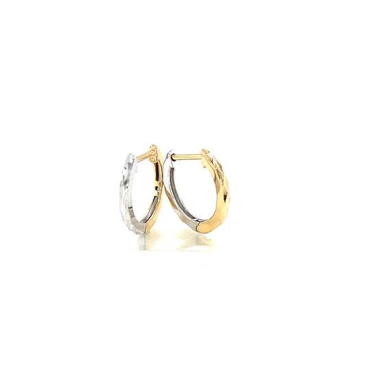 Two gold hoop earrings on a white background