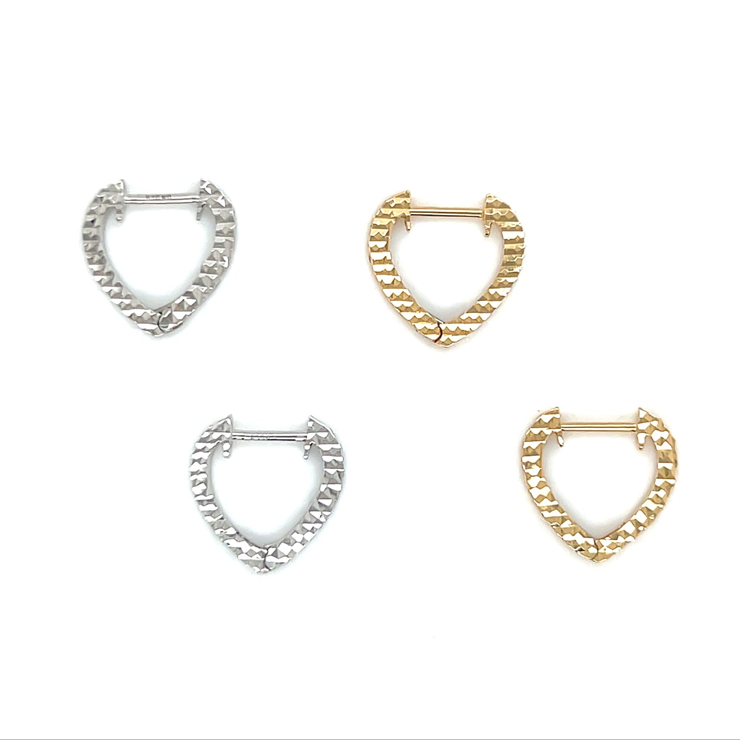 Set of four hoop earrings in silver and gold on a white background