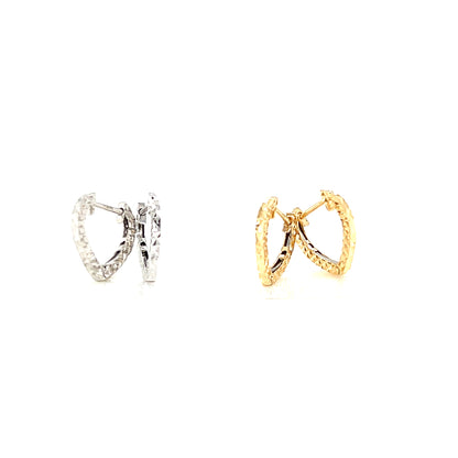 Pair of gold and silver hoop earrings on a white background