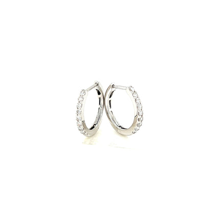 Pair of white gold hoop earrings on a white background