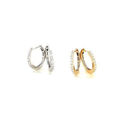 Pair of gold and platinum diamond hoop earrings on a white background