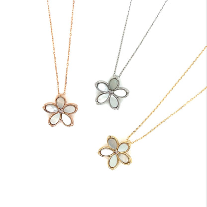 Three flower-shaped pendants on necklaces with rose gold, silver, and gold chains on a white background.