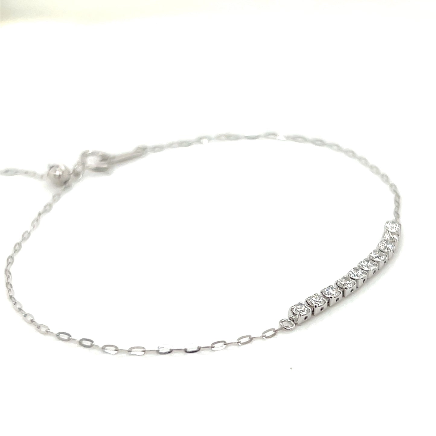 Platinum bracelet with row of diamonds on a white background