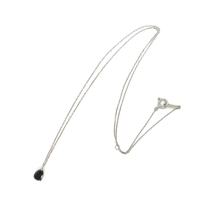 Platinum necklace with a black diamond pear shape pendant on a white background